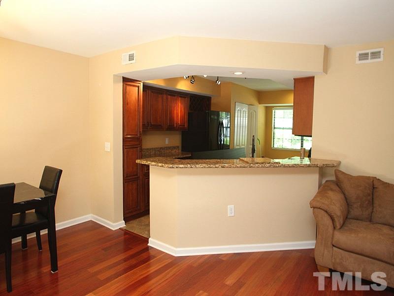 2432 Condor Court, Unit 2432 Raleigh, NC 27615 - Photo 6 of 11 a living room with a couch and wooden floor