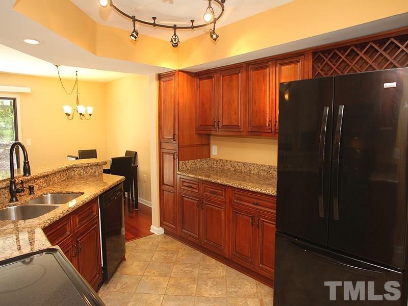 2432 Condor Court, Unit 2432 Raleigh, NC 27615 - Photo 7 of 11 a kitchen with stainless steel appliances granite countertop a refrigerator and a sink