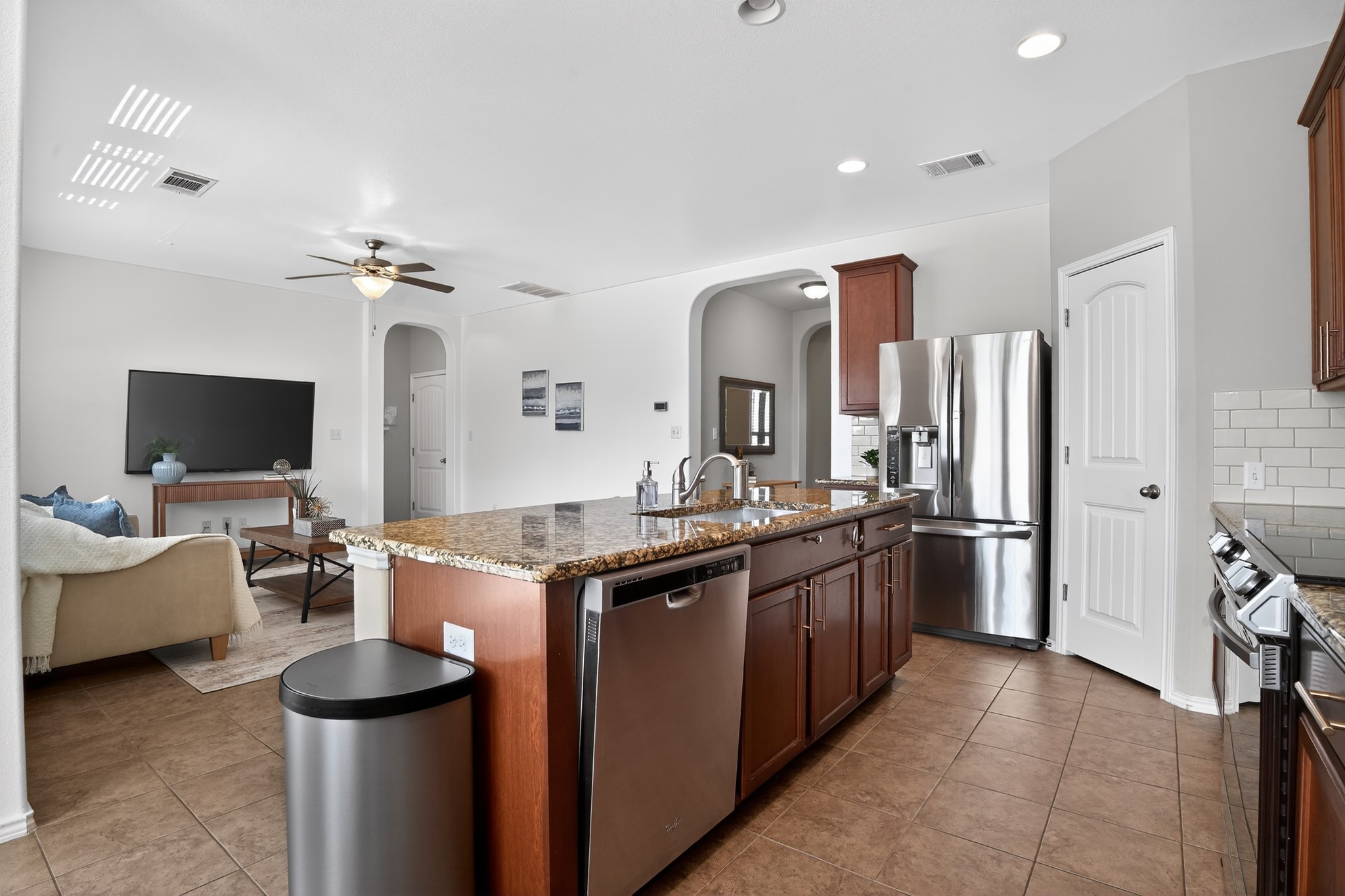 16816 Ruggio Road Pflugerville, TX 78660 - Photo 6 of 30 A gourmet kitchen offers stainless steel appliances and an oversized granite island with seating for casual dining.