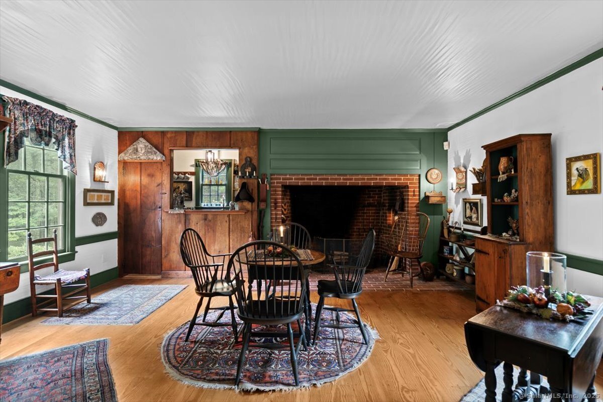 174 Bethel Road Griswold, CT 06351 - Photo 11 of 40 a dining room with furniture a fireplace and wooden floor