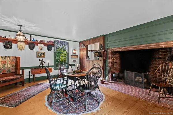a dining room with furniture a rug and a chandelier