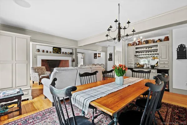 a dining room with furniture a rug and wooden floor