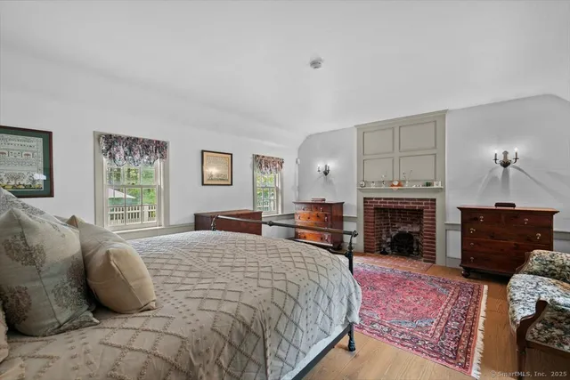 a bedroom with a bed and a fireplace