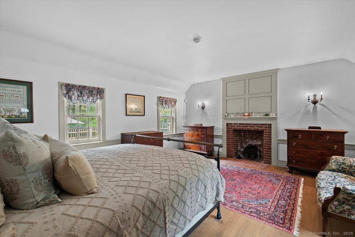 174 Bethel Road Griswold, CT 06351 - Photo 17 of 40 a bedroom with a bed and a fireplace