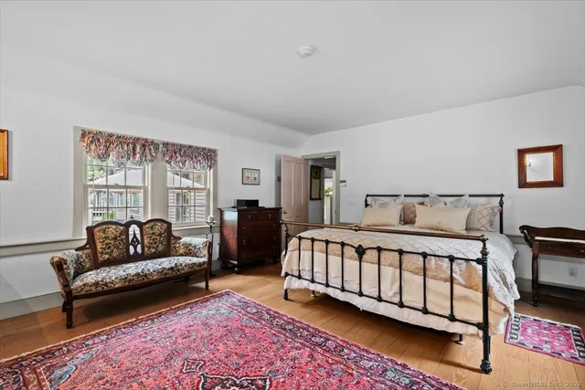 a bedroom with a bed couch and a window