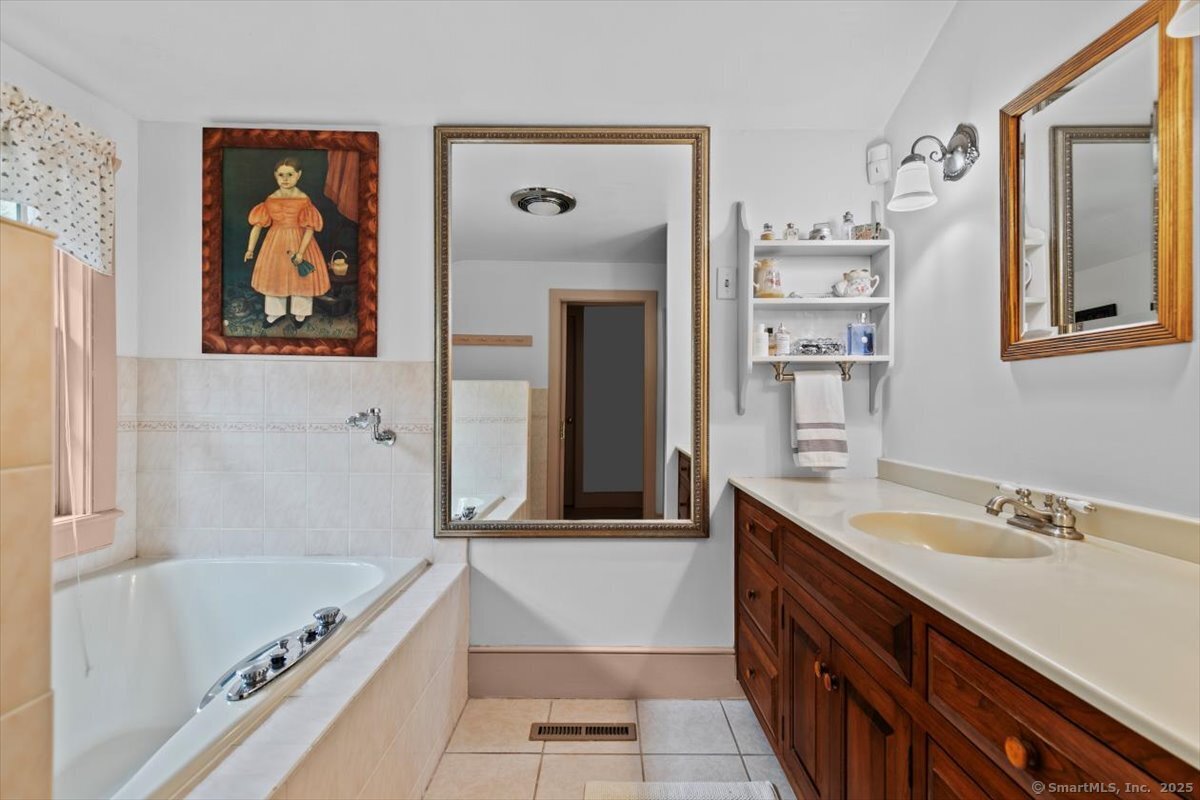 174 Bethel Road Griswold, CT 06351 - Photo 19 of 40 a bathroom with a tub a sink and mirror