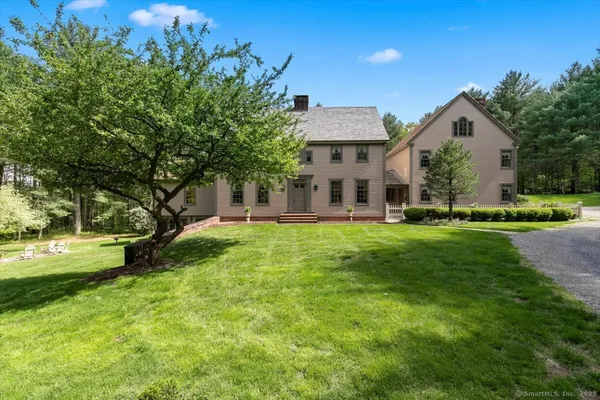 a front view of house with yard and green space