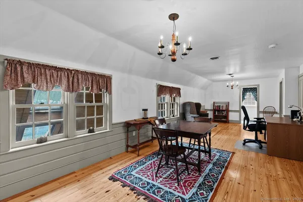 a view of a dining room with furniture window and wooden floor