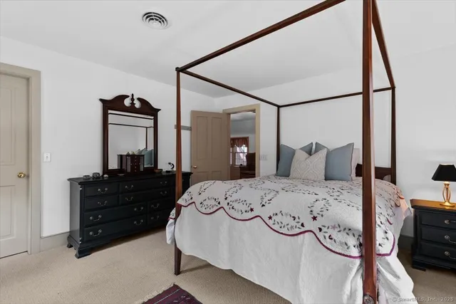 a bedroom with a bed and a dresser