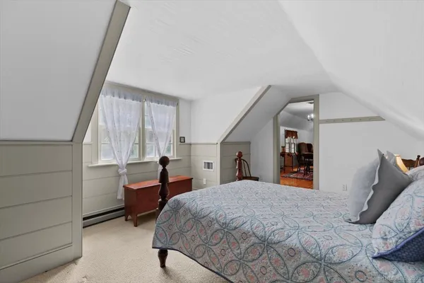 a bedroom with a large bed and a window