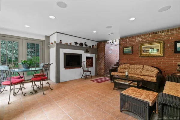 a outdoor living space with furniture and a flat screen tv