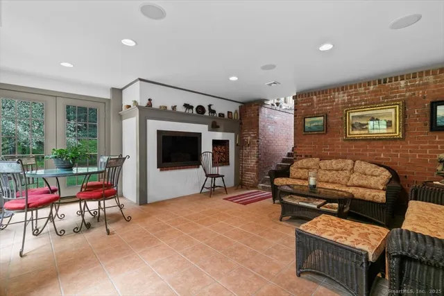 a outdoor living space with furniture and a flat screen tv