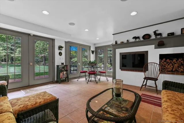 a living room with furniture and a floor to ceiling window