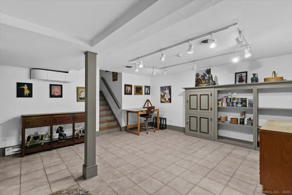 a living room with lots of furniture and white walls