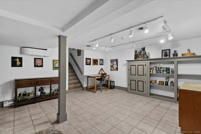 a living room with lots of furniture and white walls