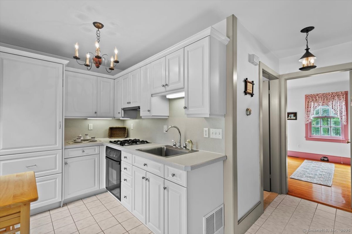 174 Bethel Road Griswold, CT 06351 - Photo 28 of 40 a kitchen that has a lot of white cabinets and stainless steel appliances