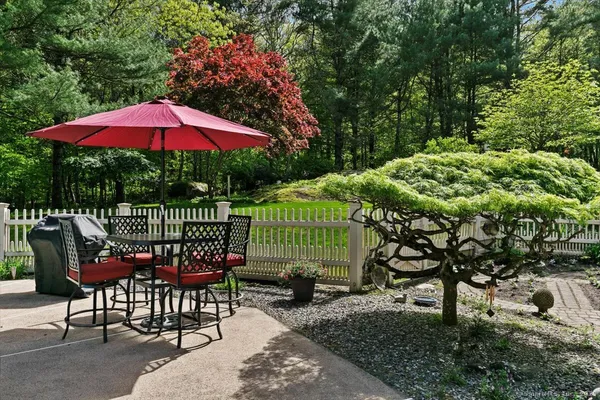 an outdoor sitting area with furniture and garden