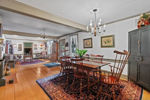 a view of a dining room with furniture and a chandelier