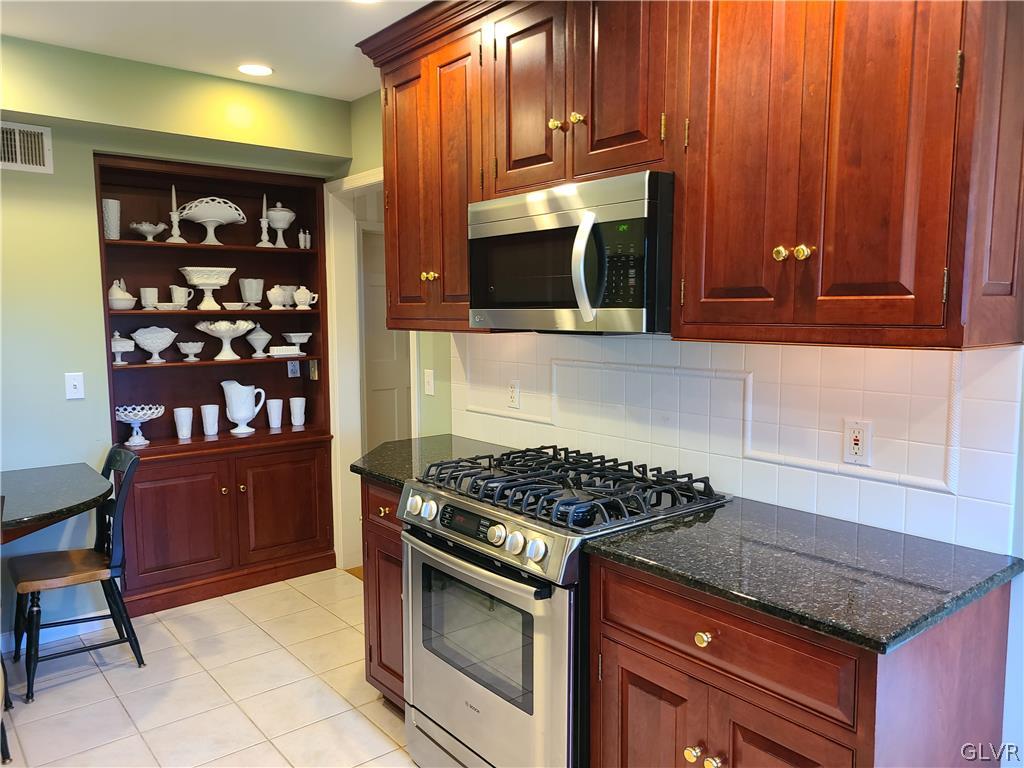 1922 Sycamore Street Bethlehem, PA 18017 - Photo 9 of 18 a kitchen with granite countertop a stove and cabinets