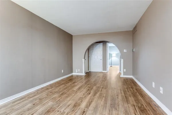 a view of a room with wooden floor