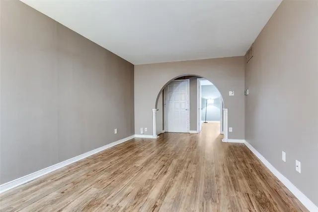 a view of a room with wooden floor