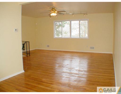 7 Barker Road Somerset, NJ 08873 - Photo 2 of 10 a view of an empty room with wooden floor and a window
