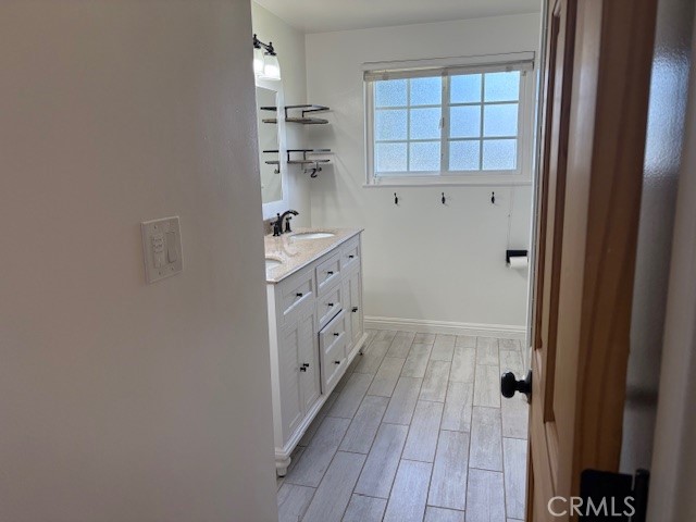 10918 Reseda Boulevard Porter Ranch, CA 91326 - Photo 12 of 19 a bathroom with granite countertop a sink a toilet and shower