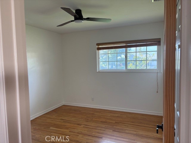 10918 Reseda Boulevard Porter Ranch, CA 91326 - Photo 13 of 19 a view of an empty room with wooden floor and a window
