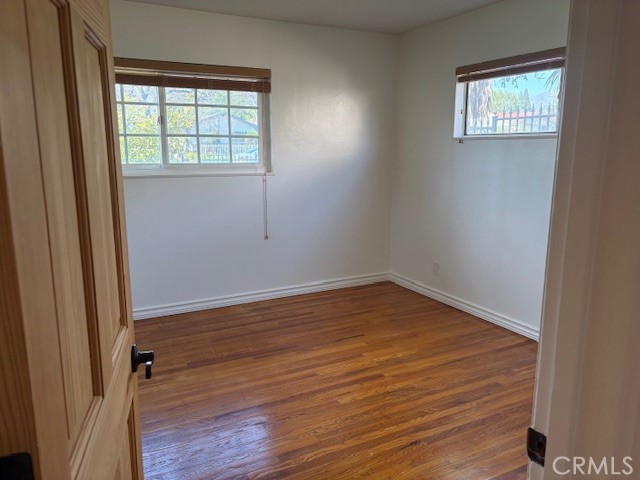10918 Reseda Boulevard Porter Ranch, CA 91326 - Photo 14 of 19 an empty room with wooden floor and windows