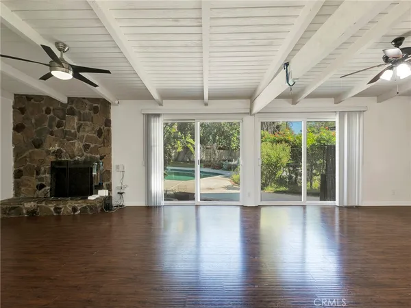 a backyard of a house with barbeque oven table and chairs