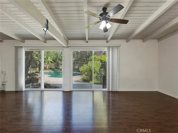 a view of a backyard with plants and a patio
