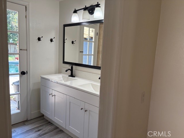 10918 Reseda Boulevard Porter Ranch, CA 91326 - Photo 16 of 19 a bathroom with a granite countertop sink and a mirror