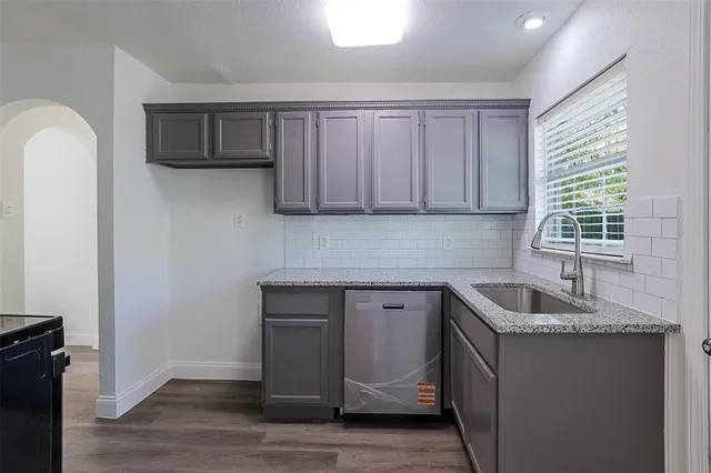a kitchen with sink cabinets and window