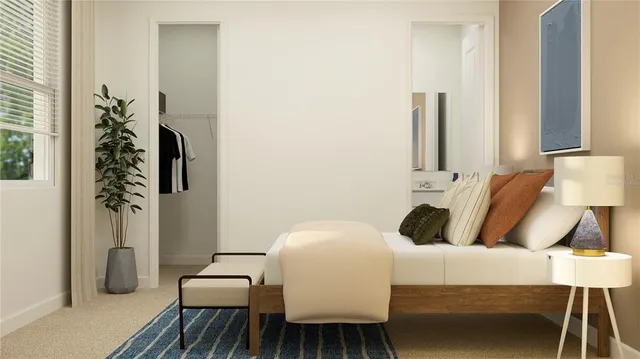 a bedroom with a bed and a table chair