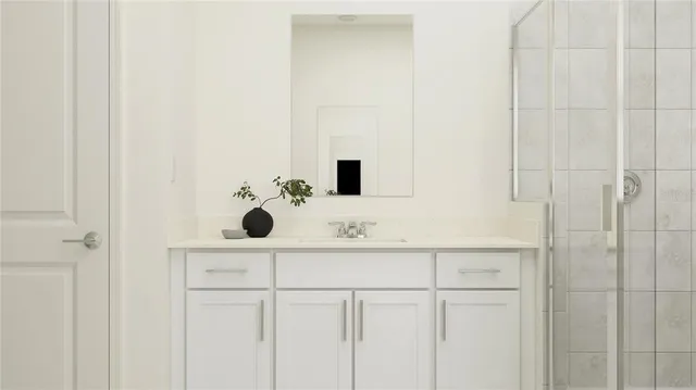 a bathroom with a sink vanity and mirror