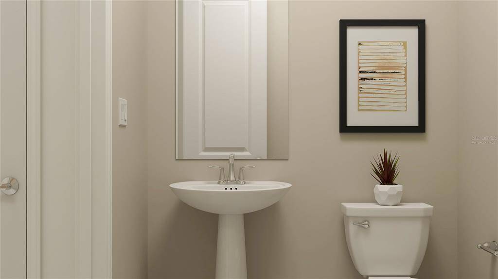 5635 Banyan Bay Road St. Cloud, FL 34771 - Photo 9 of 34 a bathroom with a sink a mirror and a toilet