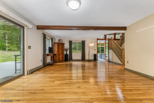 a view of a livingroom with wooden floor and furniture