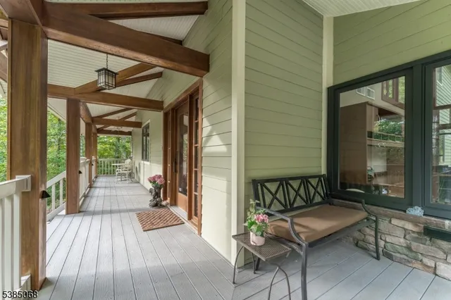 a balcony with wooden floor and glass door