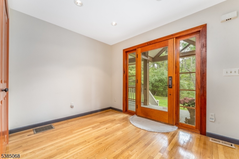 168 Locktown Sergeantsville Road Stockton, NJ 08559 - Photo 6 of 30 a view of an empty room with wooden floor and a window
