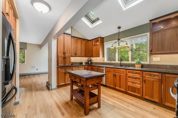 a kitchen with a sink a window and stainless steel appliances