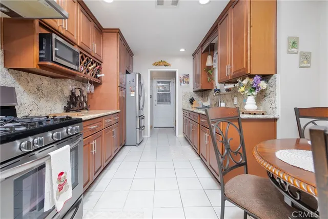 a kitchen with stainless steel appliances granite countertop a sink and cabinets