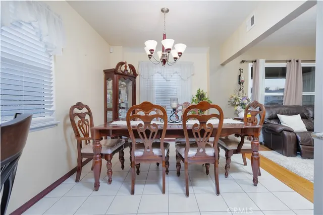 a view of a dining room with furniture and chandelier