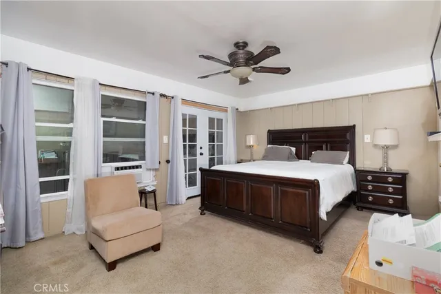 a bedroom with a large bed and a couch