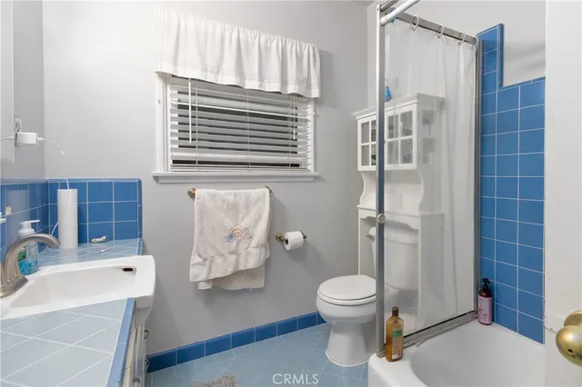 a bathroom with a toilet sink and shower