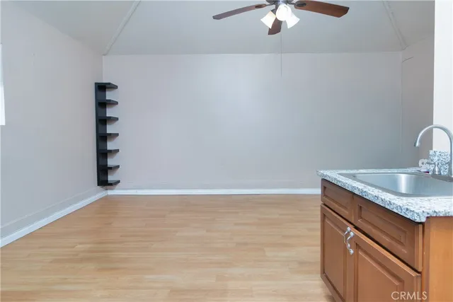 a view of a kitchen with a sink cabinets and appliances