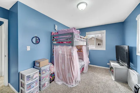 a bedroom with furniture and a flat screen tv