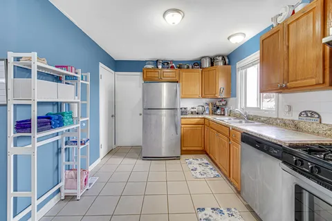 a kitchen with a sink a refrigerator and cabinets