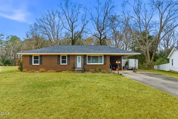 a view of a house with a yard and sitting area