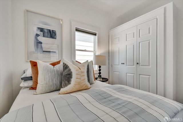 a bedroom with a bed and a window