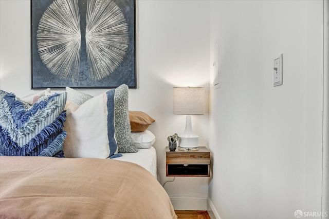 a bedroom with a bed and a lamp